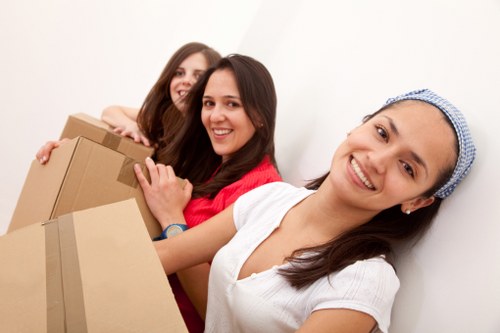 Movers wrapping and securing furniture for transport in Tufnellpark
