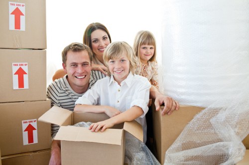 Professional movers loading furniture for a same day removal service